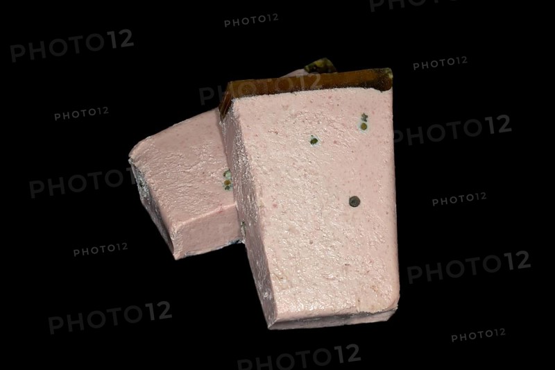 Halved liver pate with aspic and fresh green pepper