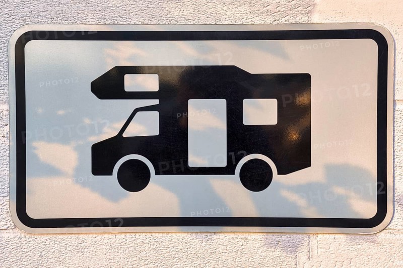 Sign with pictogram camper van on a wall