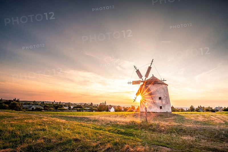 The Old Windmill of Tes in the sunset with guests