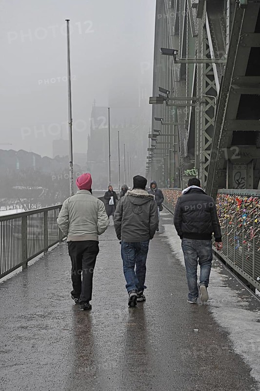 Indian Sikhs on Hohenzollern Bridge with fence of love locks