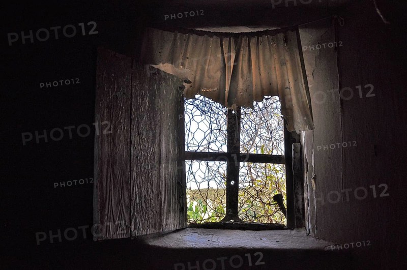 Window with plastic curtain in abandoned house