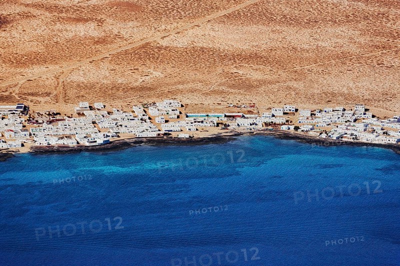 View of the white houses of Caleta del Sebo by the sea