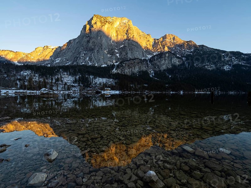 Evening sun illuminates the Trisselwand at Lake Altaussee