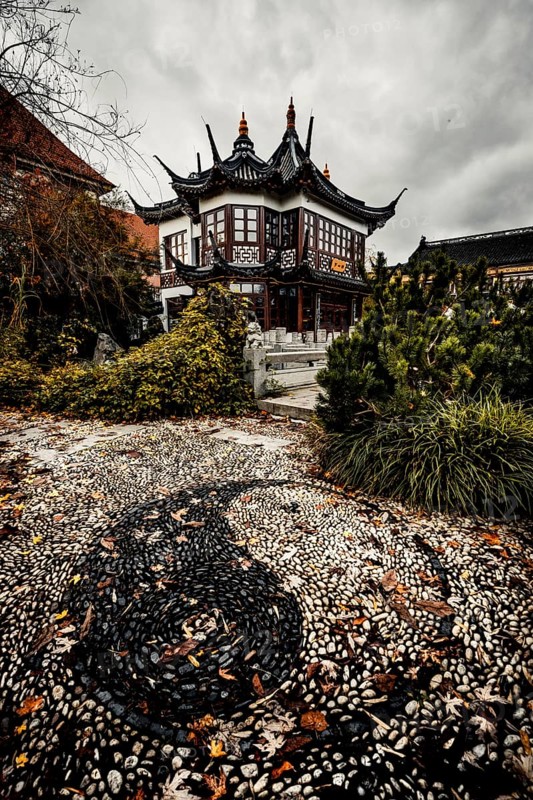 China restaurant with a great park and yin yang signs made of stones in the path