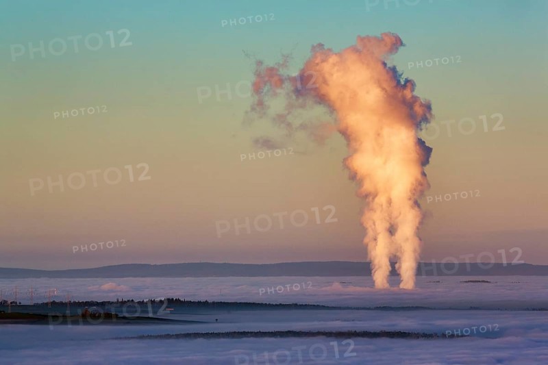 Two columns of steam rising from cloud cover