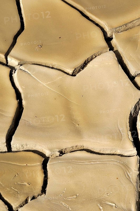 Dried clay soil with deep furrows