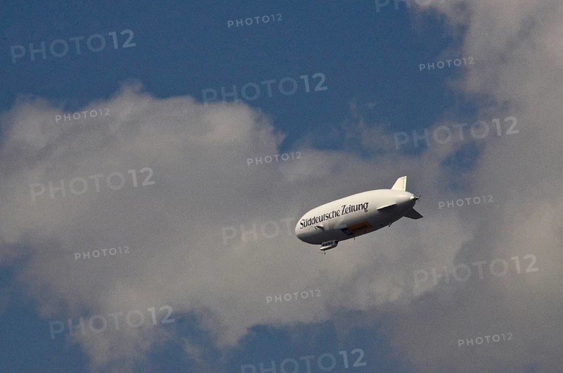 Zeppelin with inscription Sueddeutsche Zeitung in the sky with clouds