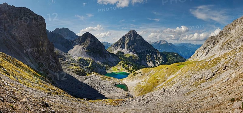 Mountain panorama above the Drachensee and the Coburger Huette with the mountain peaks of the Sonnenspitze