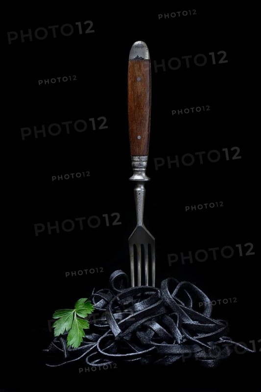 Black pasta with squid ink with fork