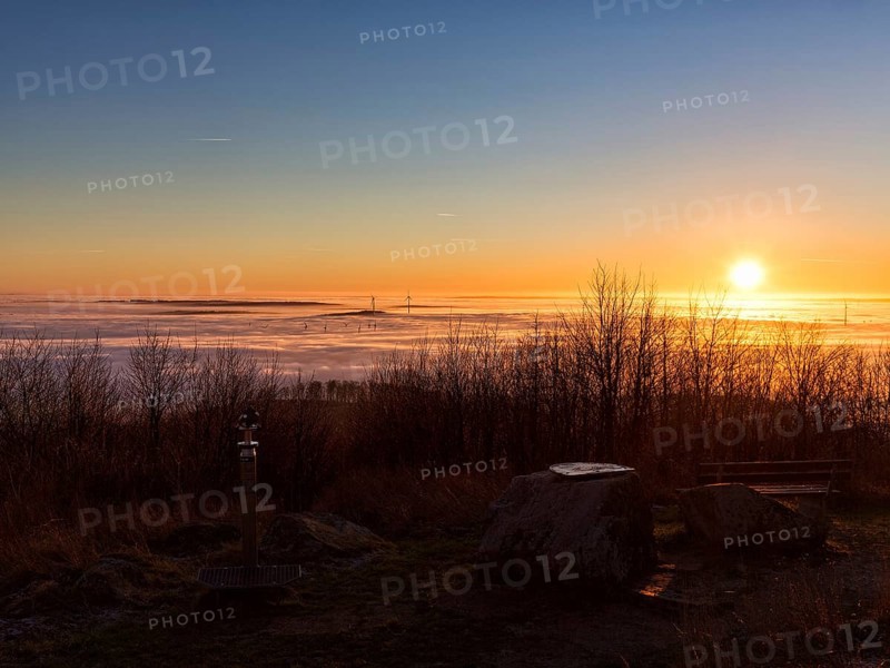 Sunset over cloud cover on mountain top