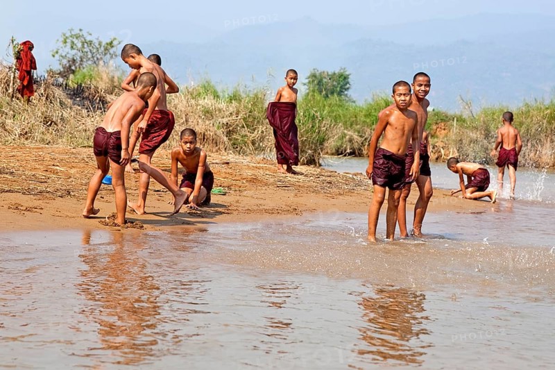 Bathing monks on the banks of the Nam Pilu River