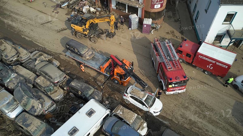 A tow truck loads wrecked cars washed away by the floods on the Ahr river in Dernau. Dernau