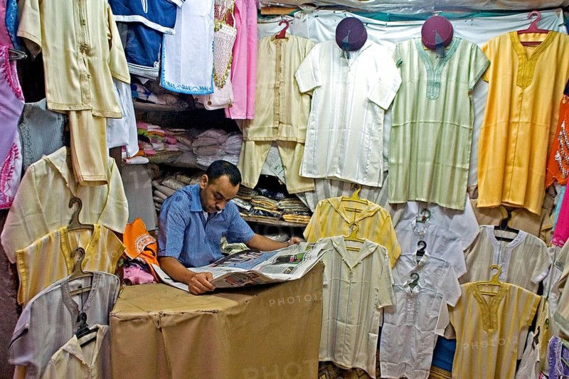 Vendor reading a daily newspaper