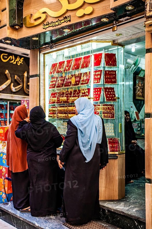 Women in front of displays of a gold jewellery shop