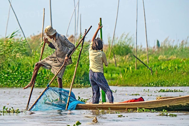 Fishermen with fish trap and nets