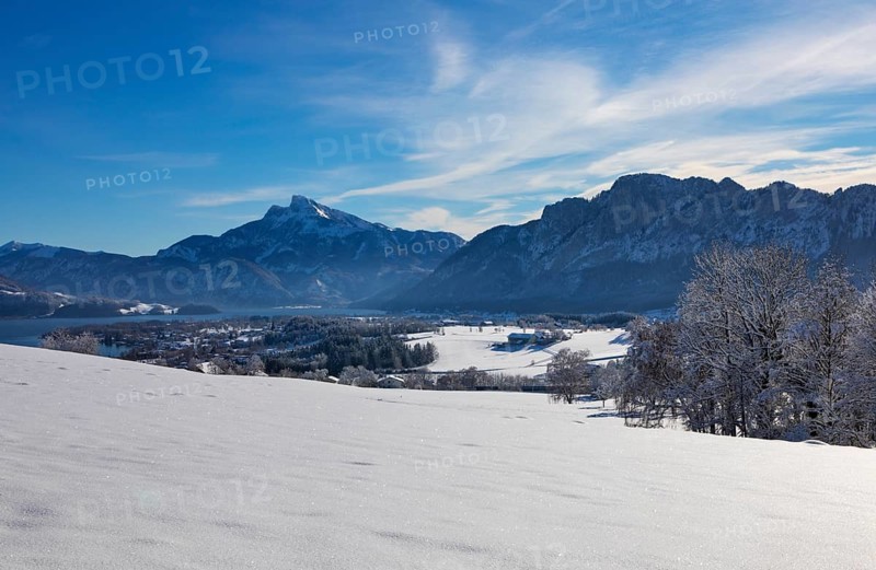 View of snow-covered Mondseeland with Schafberg and Drachenwand