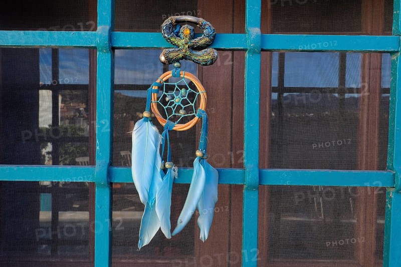 Andalusian Lucky Charm Indalo and Dreamcatcher on Iron Grille of Window