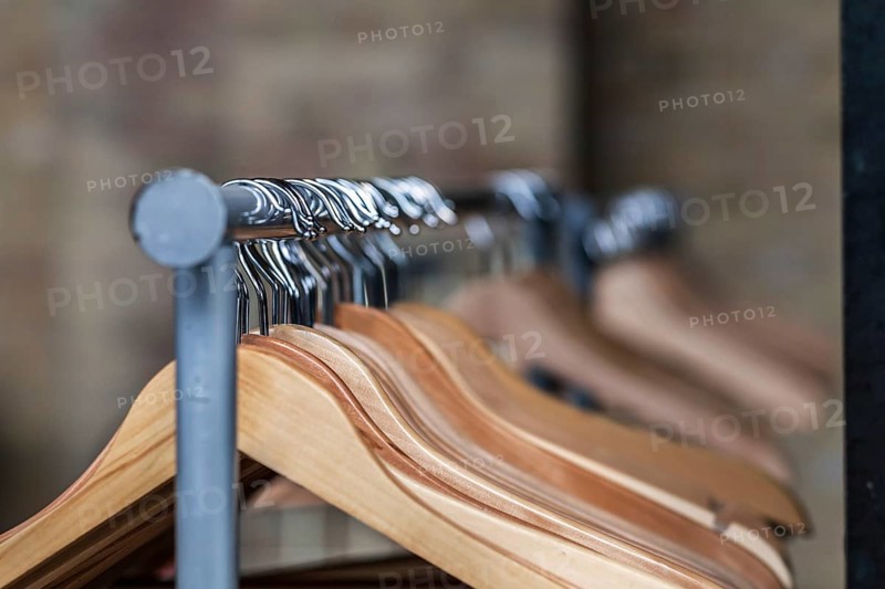 Wooden hanger on a coat rack