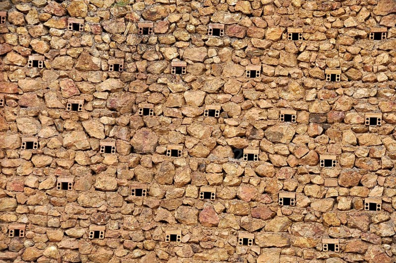 Natural stone wall of a mine with ventilation holes