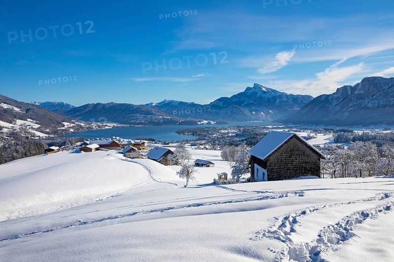 View of snow-covered Mondseeland with Schafberg and Drachenwand