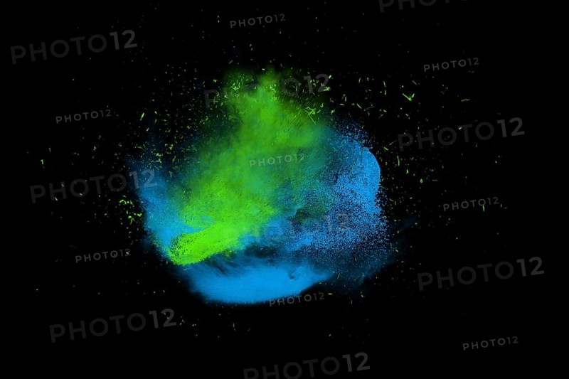 Freeze motion of blue and green powder paint exploding isolated on black