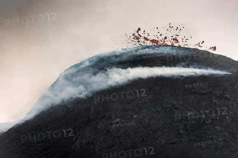 Glowing lava spurting from crater
