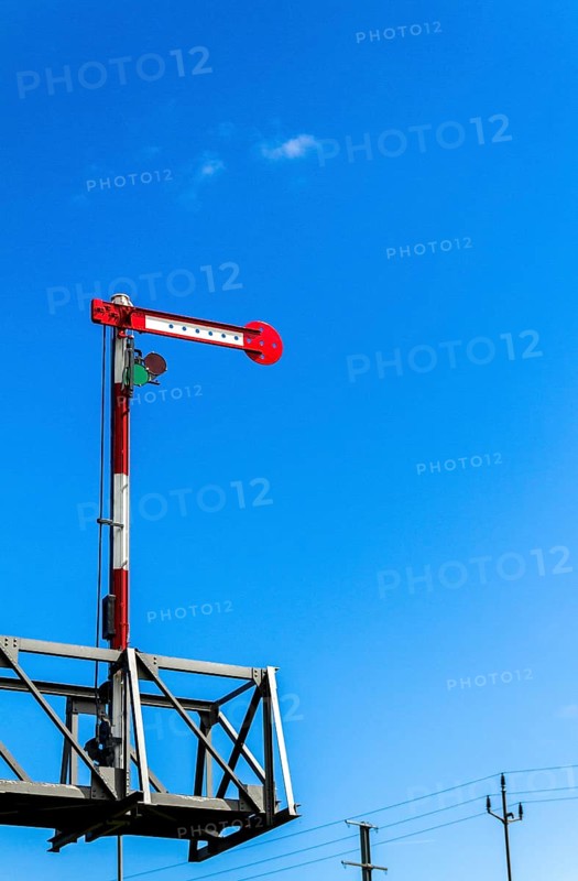 Railway signal against a blue sky