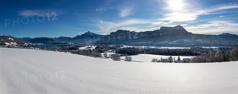 View of snow-covered Mondseeland with Schafberg and Drachenwand