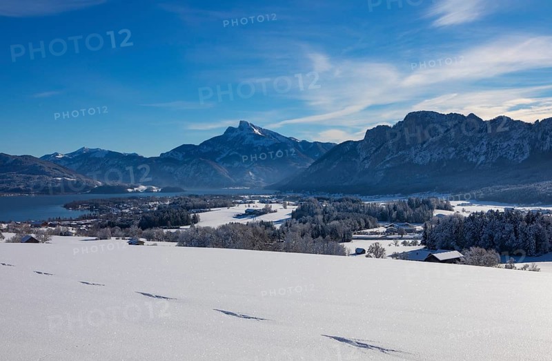 View of snow-covered Mondseeland with Schafberg and Drachenwand
