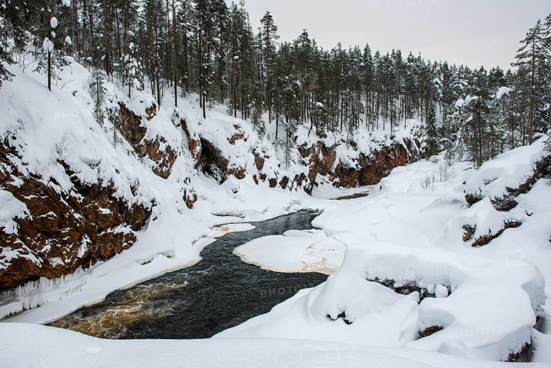Snowy winter landscape with river course in Oulanka National Park