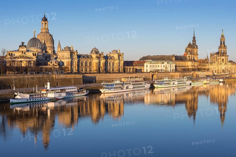 City view with excursion boats in the morning light with reflection in the Elbe