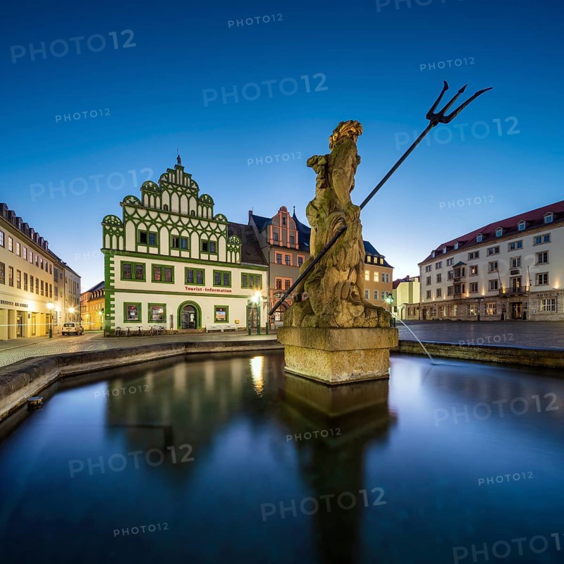 Renaissance houses on the market square with the Neptune Fountain at dawn