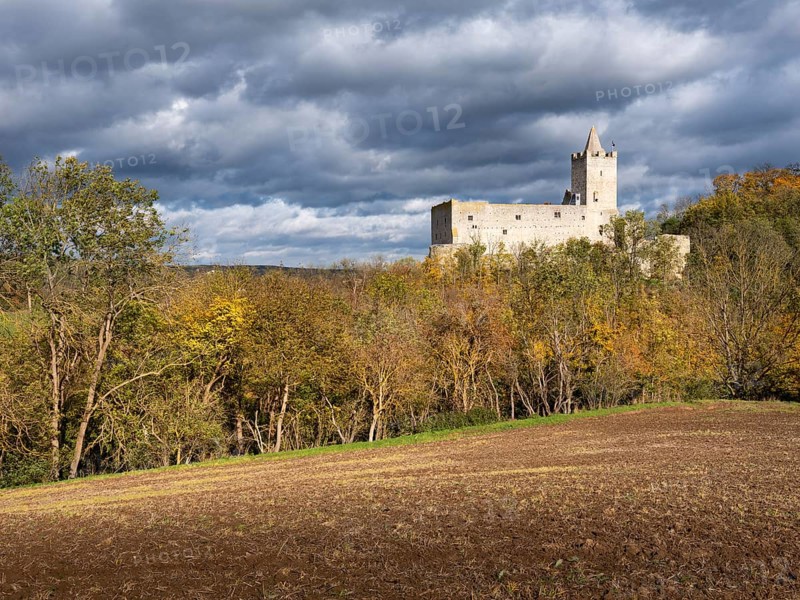 Rudelsburg castle ruins in the Saale valley in autumn under dark clouds