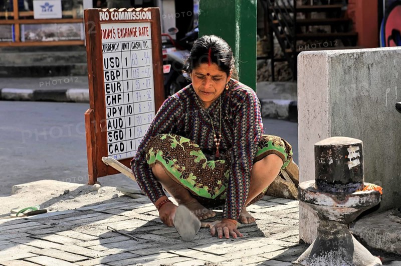 Nepalese woman repairing the road