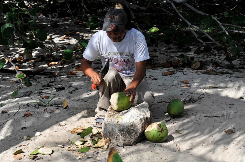 Man opening a coconut