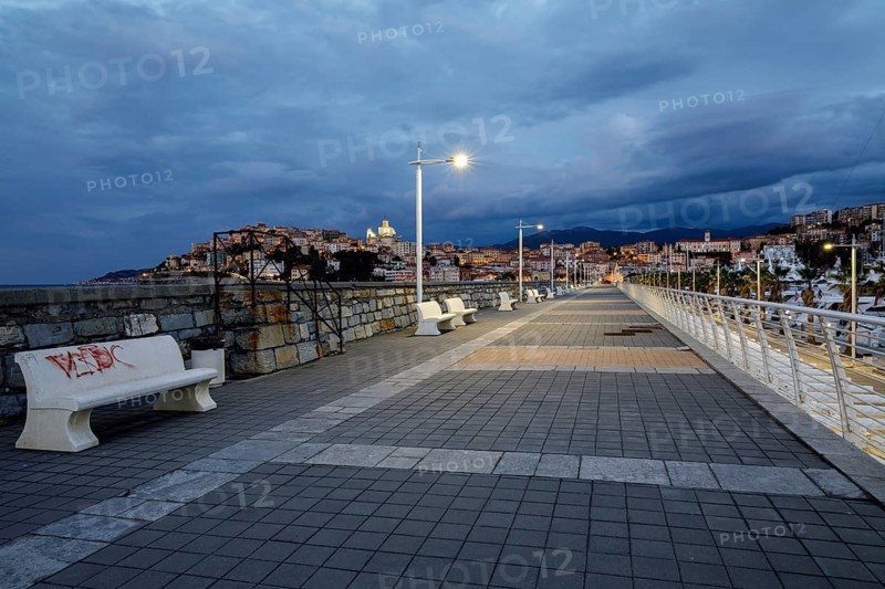 Sunrise with lighthouse at the harbour pier in Porto Maurizio
