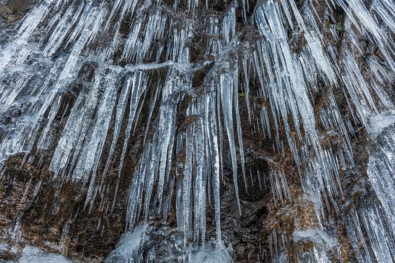Icicles forming an icefall in the mountain in winter. France