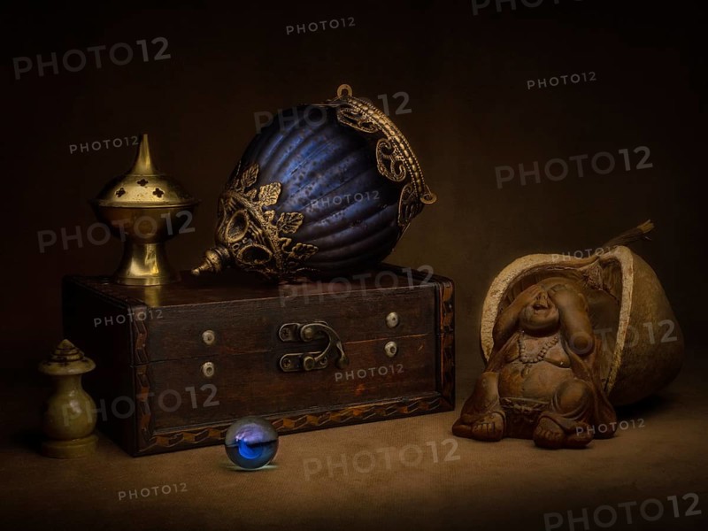 Still life with incense holder and oriental hanging lamp on wooden box