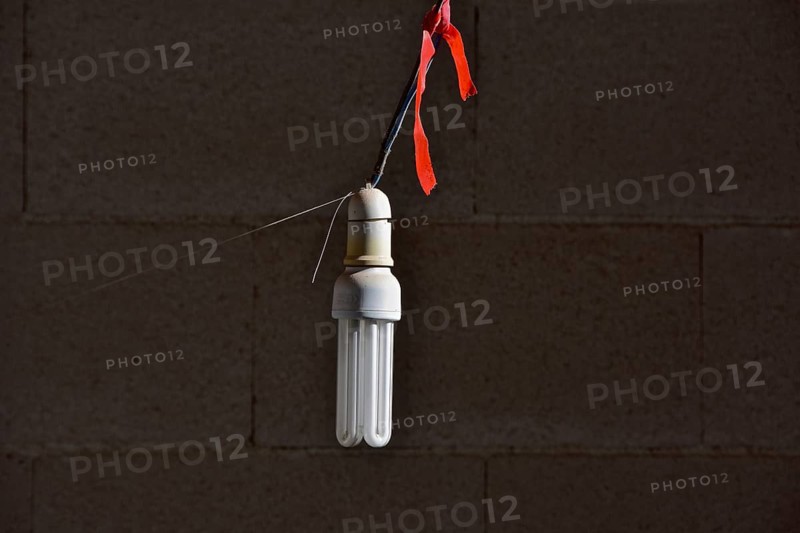 Energy-saving light bulb hangs on rope