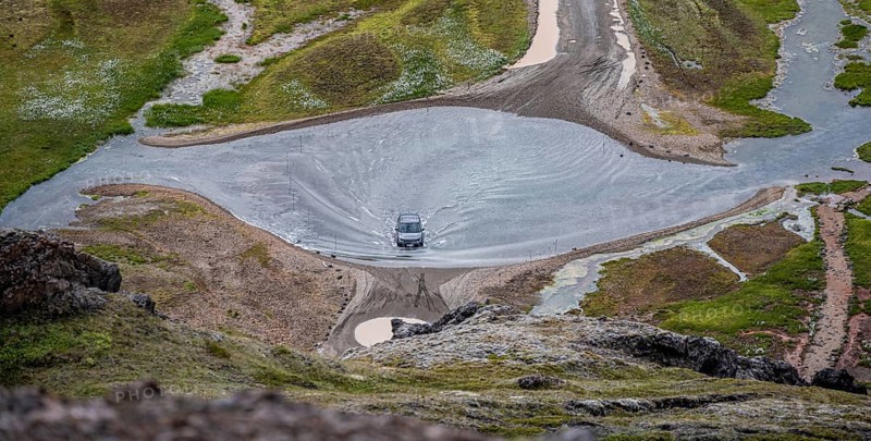 Car drives through ford at Landmannalaugar Camp