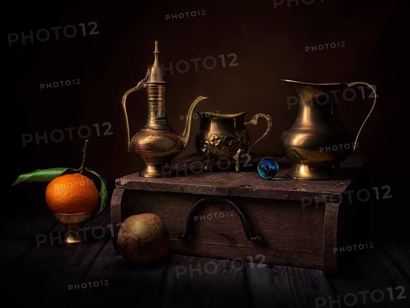 Still life with oriental vessels and glass ball on wooden box