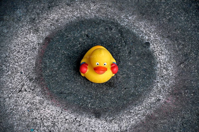 Yellow rubber duck sitting in a circle on the floor