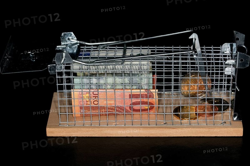 Euro coins and paper money lying in a live trap for mice
