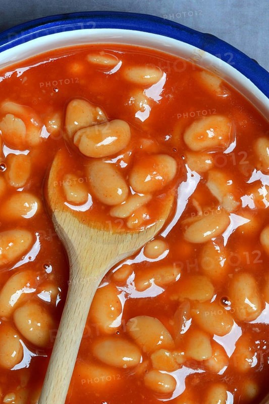 White beans with tomato sauce and cooking spoon