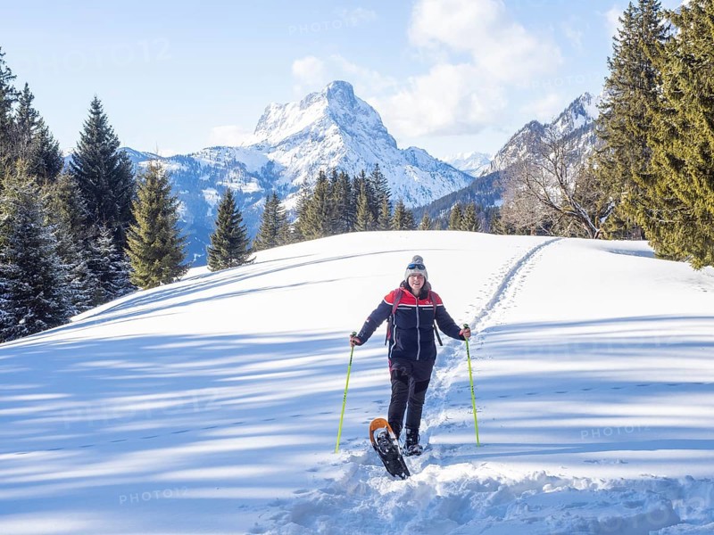 Snowshoe hiker in winter landscape