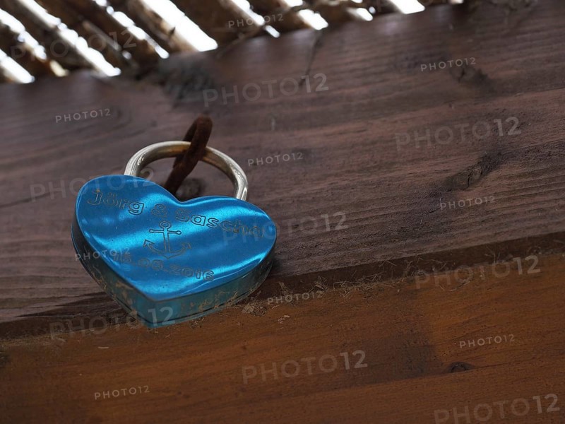 Love lock on wooden wall of gay couple