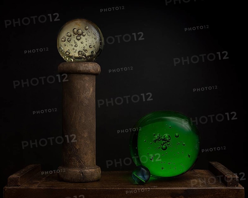 Still life with glass balls and wooden spool