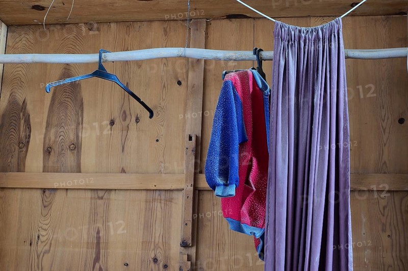 Empty wooden cupboard with curtain
