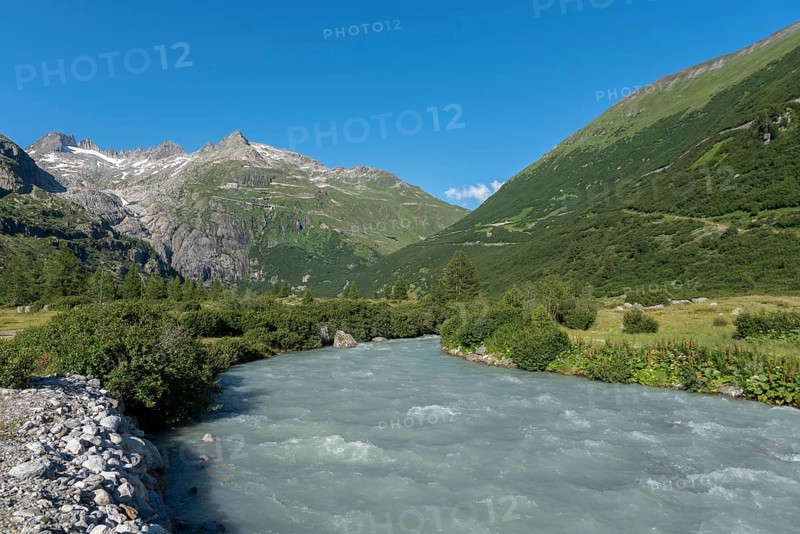 Landscape of the Rhone Valley with the Rhone River in front of the massif of the Rhone Glacier