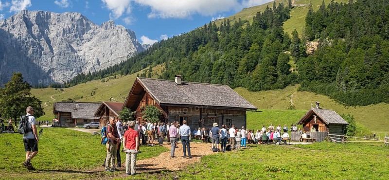 Mass celebration on Almkirtag in front of the wooden chapel in the alpine village of Eng